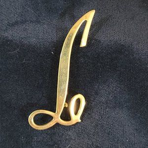 Gold toned "L" brooch